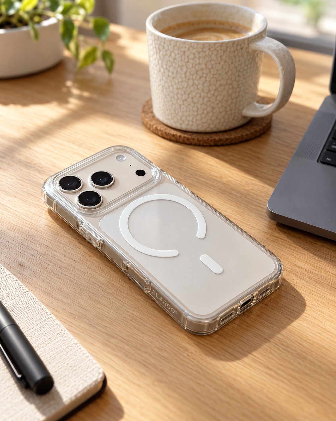 ELARDO clear MagSafe case on an iPhone lying on a sunlit oak desk